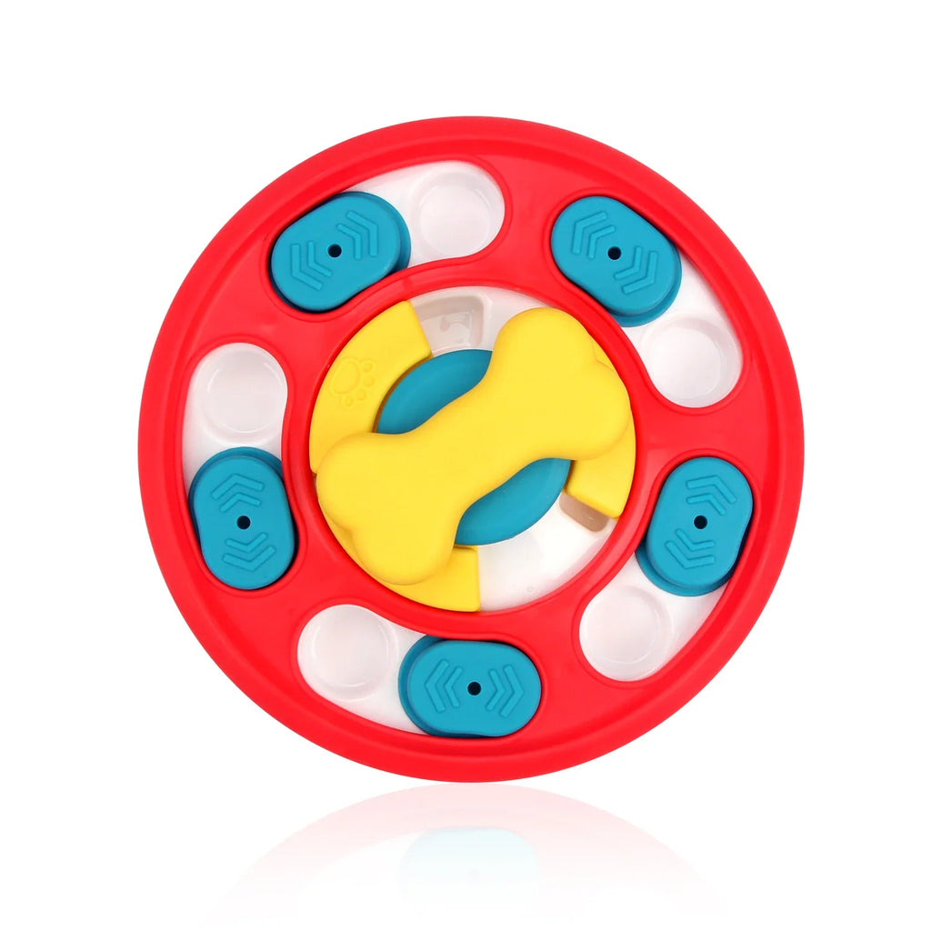 Round slow feeder puzzle toy for dogs. Colorful toy with a red border, yellow center, and blue and white accents.  
