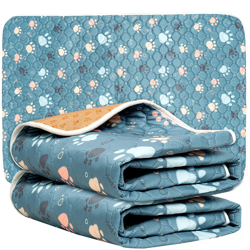 Folded blue blanket with paw print pattern on a white background - Waterproof pet mat for dogs and cats suitable for potty training, travel, and home use