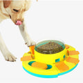 Dog interacting with a colorful puzzle toy designed to release treats. Interactive dog enrichment toy with treat compartments.