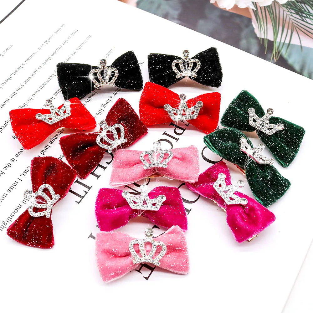 Set of colorful hair bows with crowns on a magazine page background. Cute dog hair accessories with glitter bows for small dogs.