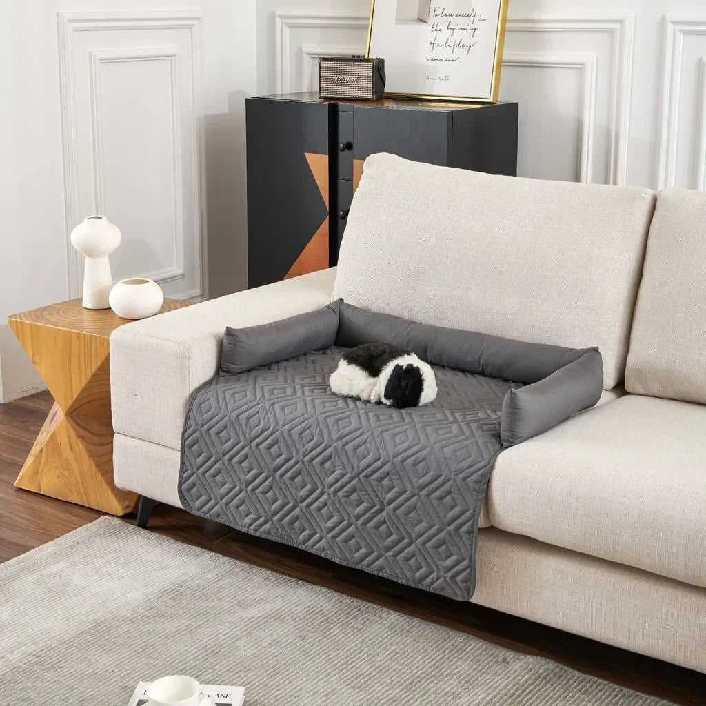 Gray pet bed on a beige sofa in a living room setting - Waterproof pet blanket mat placed on couch from fur and spills 