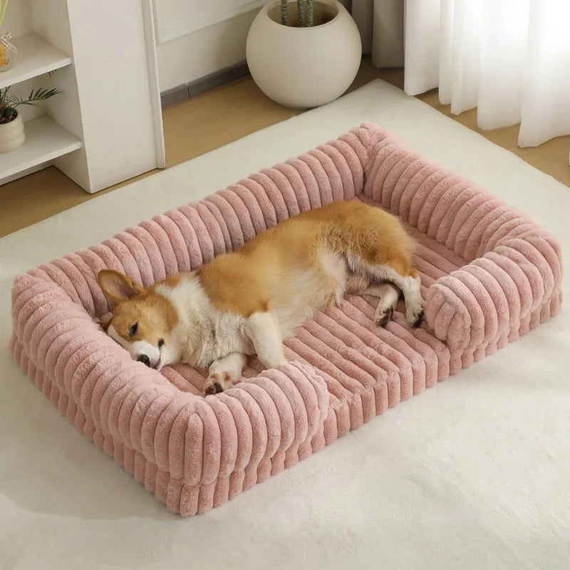 Dog lying on a pink orthopedic pet bed with removable washable cover.