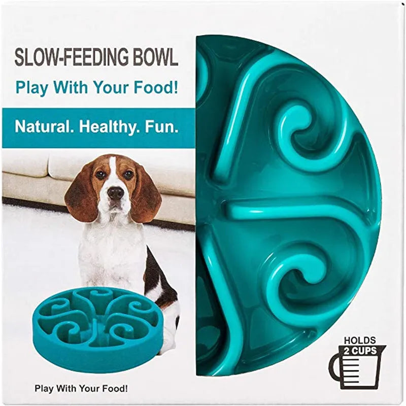 Turquoise slow-feeding dog bowl with packaging featuring a dog and text about the product. Non-slip interactive feeding bowl for dogs.