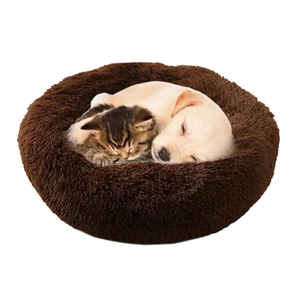 Round brown pet bed with a kitten and puppy sleeping inside on a white background - Luxury faux fur pet bed with raised calming edges.