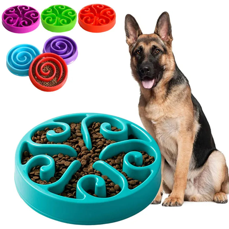 Dog sitting next to a blue slow feeder with food, surrounded by colorful pet toys. Non-slip slow feeder dog bowl with raised feeding pattern. 