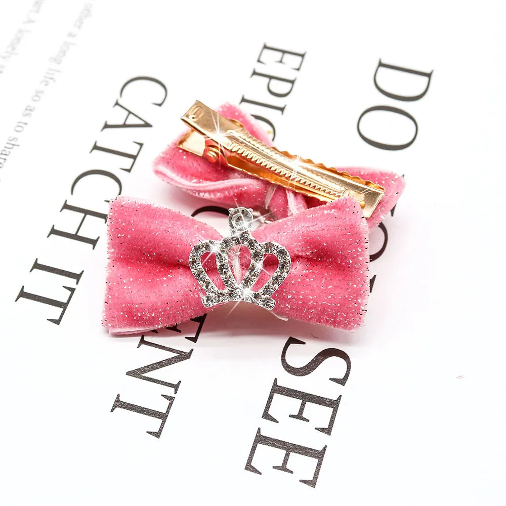 Pink glittery hair bow with a crown brooch on a white background with text. Pet hair accessories with glitter bows for stylish puppies.