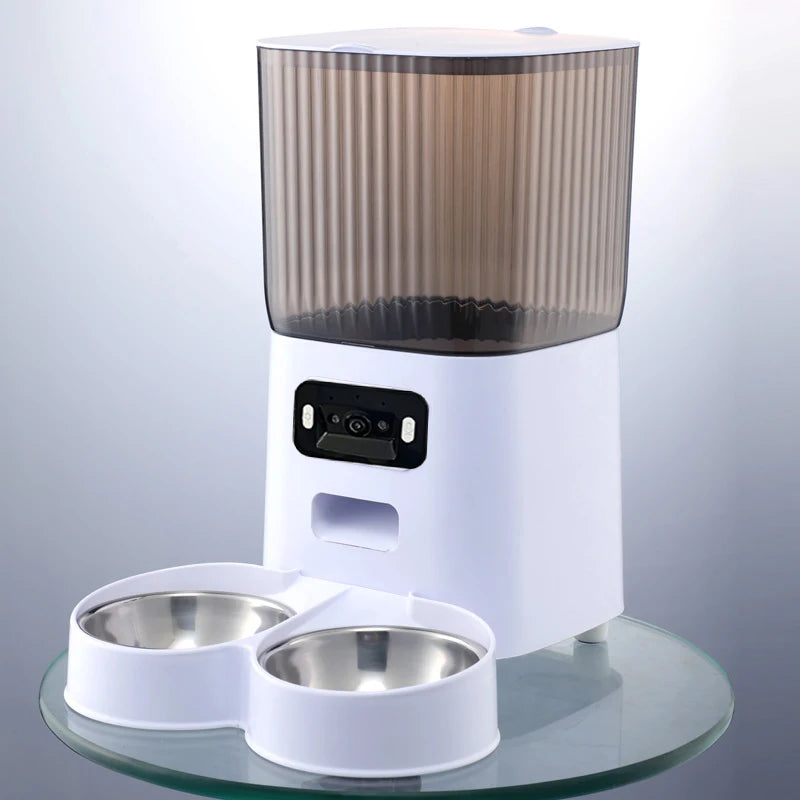 Pet feeder with two bowls on a clear surface -Dual bowl feeder with programmable meal scheduling.